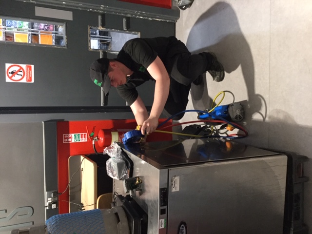 JFCS engineer servicing a commercial undercounter fridge with refrigerant gauges